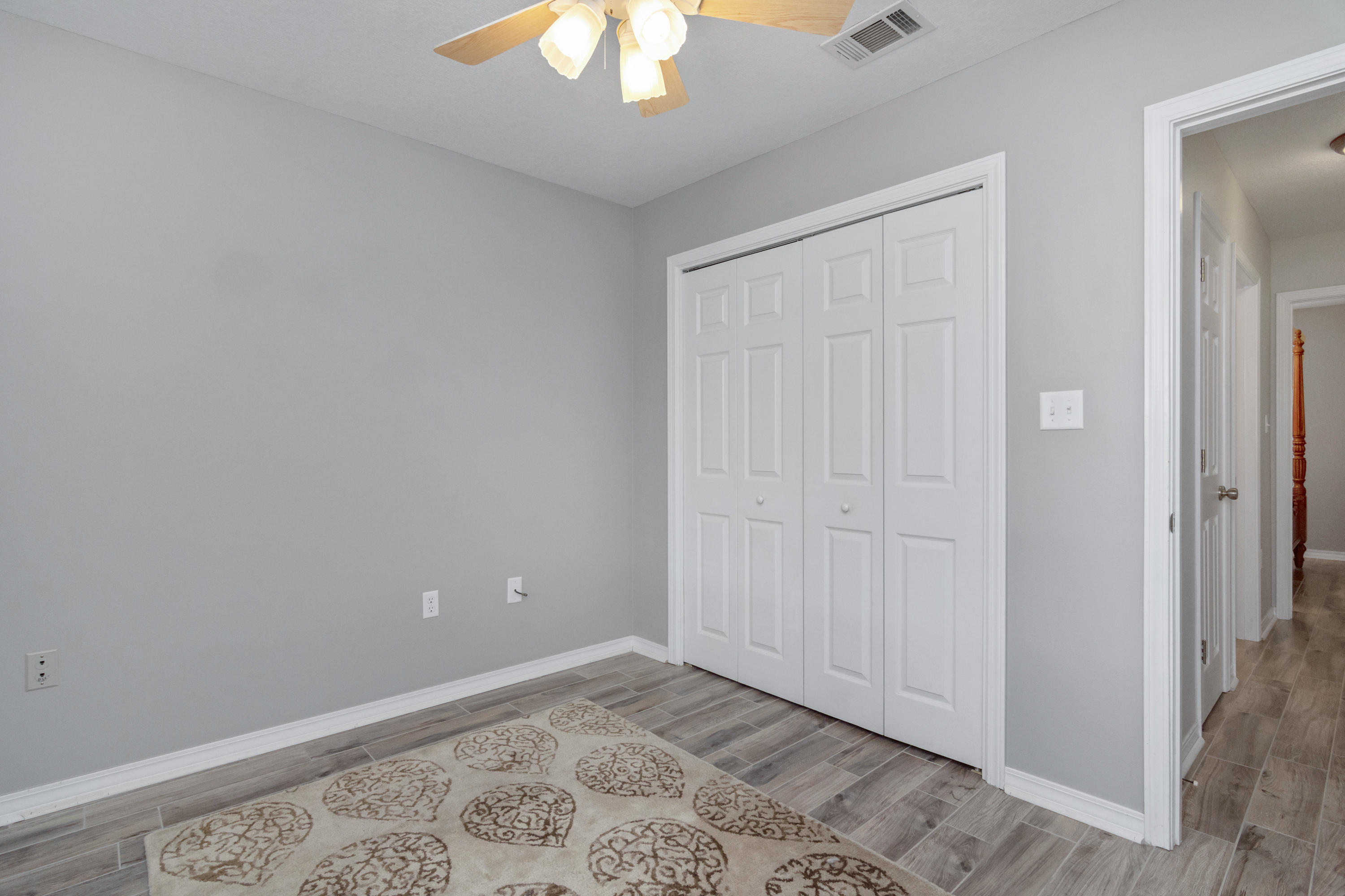 5780 Griffith Mill Road Baker, FL 32531 - Photo 27 of 50 an empty room with a chandelier fan