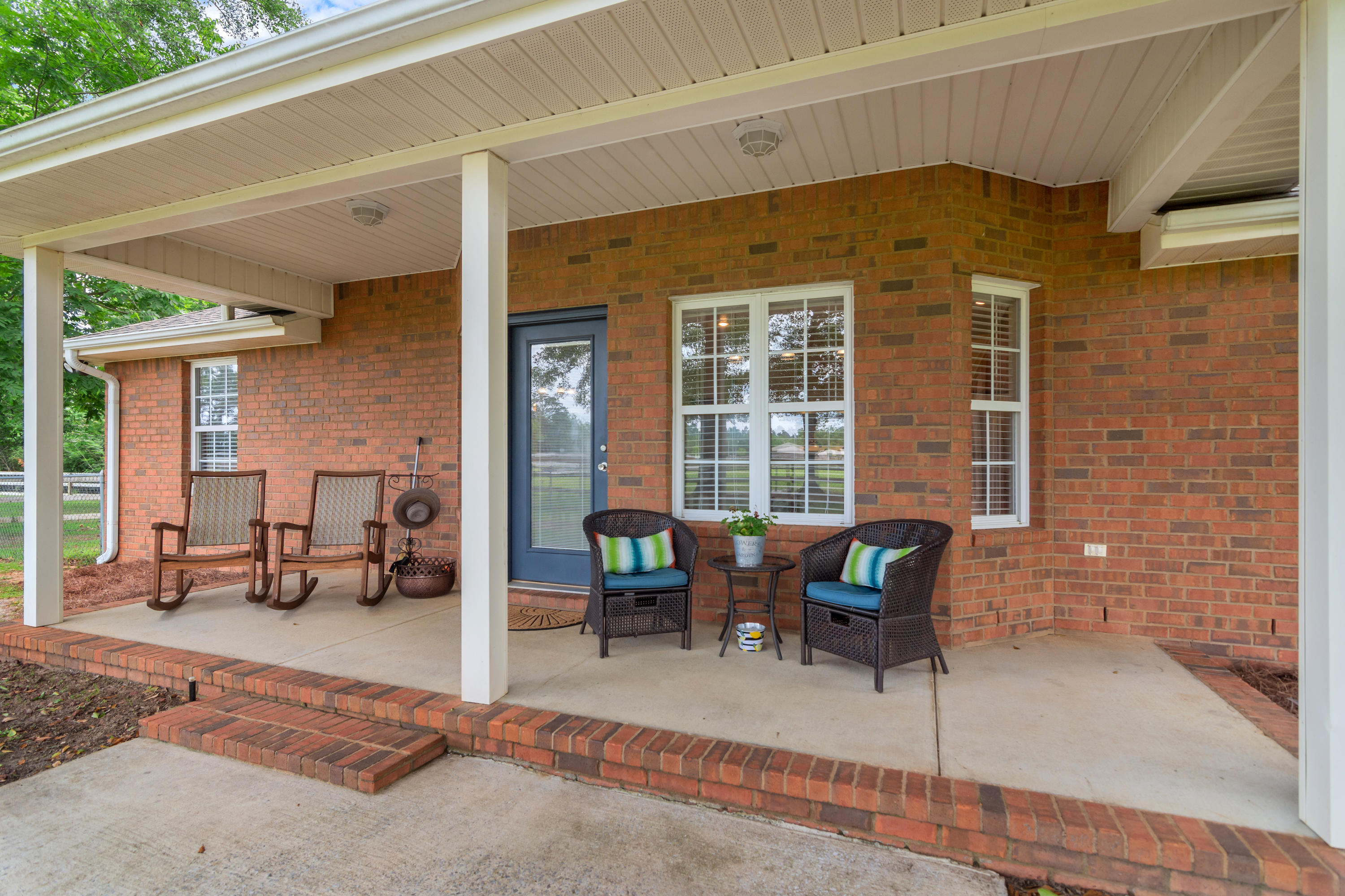 5780 Griffith Mill Road Baker, FL 32531 - Photo 32 of 50 a view of a patio with table and chairs and wooden floor