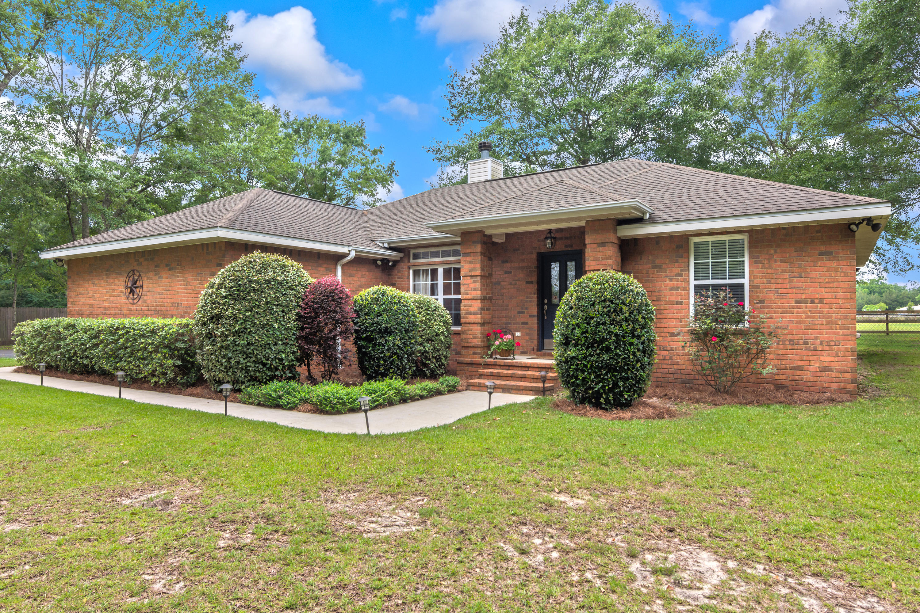 5780 Griffith Mill Road Baker, FL 32531 - Photo 5 of 50 a view of a house with a yard and potted plants