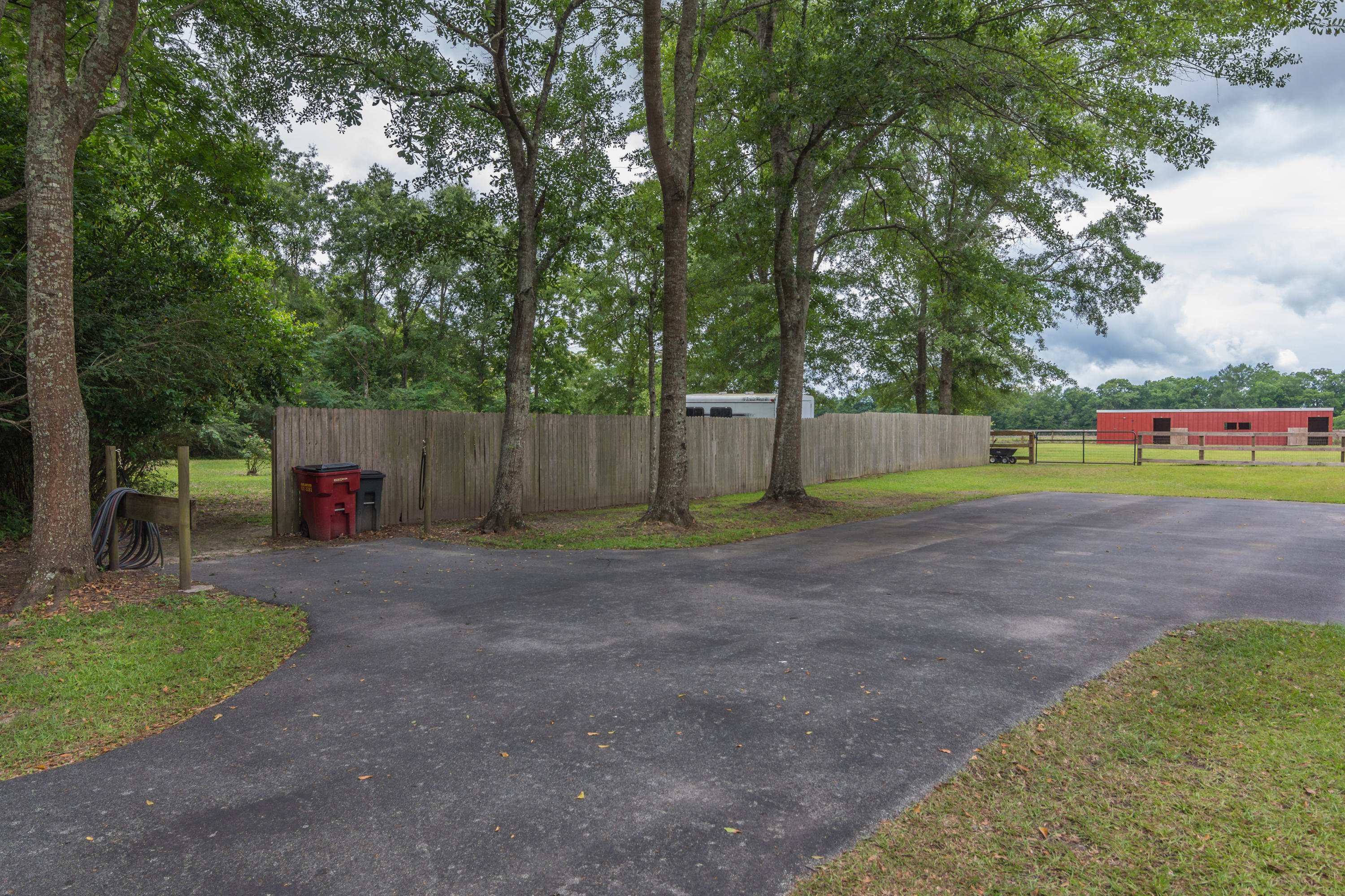 5780 Griffith Mill Road Baker, FL 32531 - Photo 42 of 50 a view of a park with large trees and wooden fence