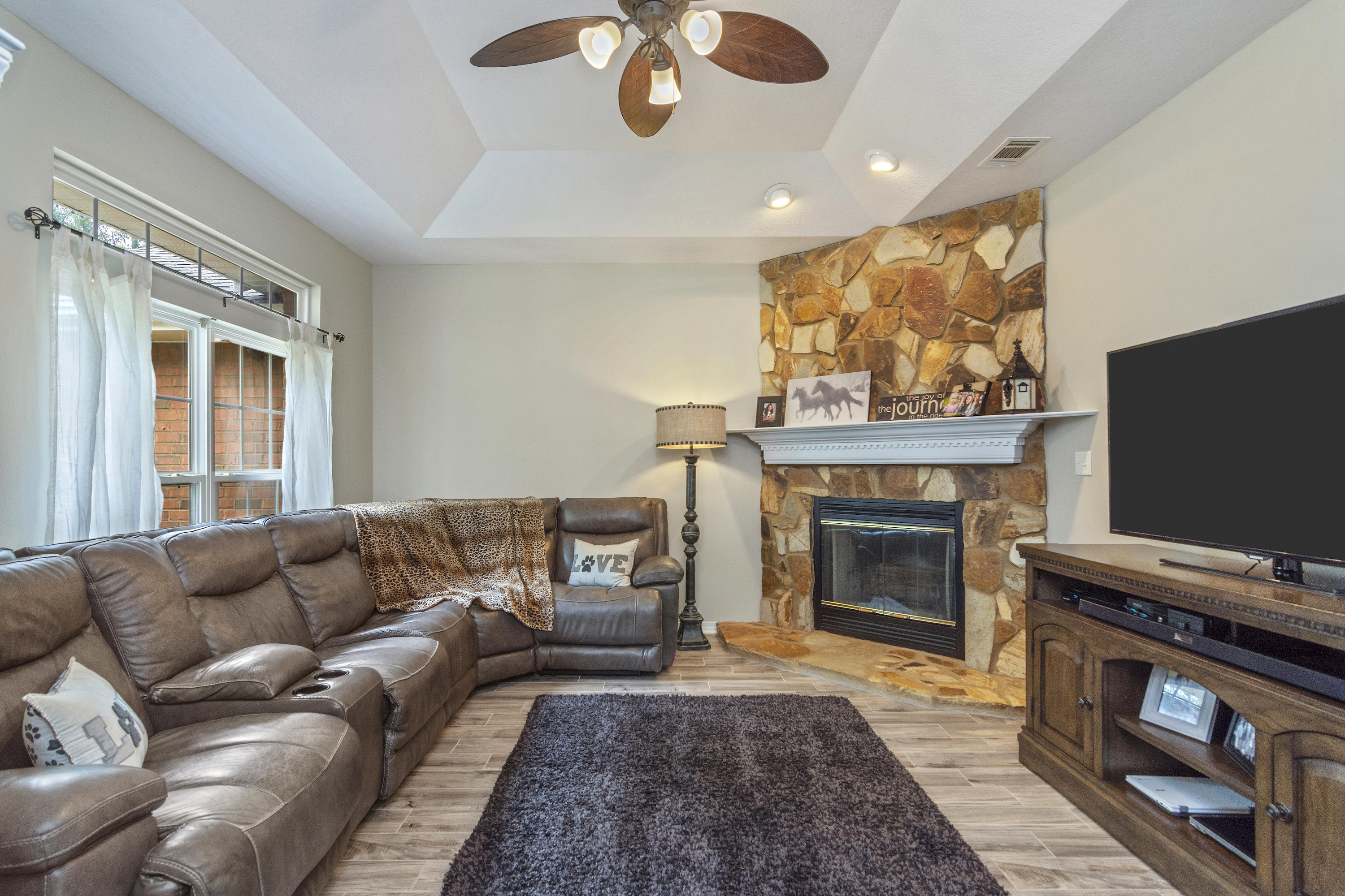 5780 Griffith Mill Road Baker, FL 32531 - Photo 10 of 50 a living room with furniture a flat screen tv and a fireplace