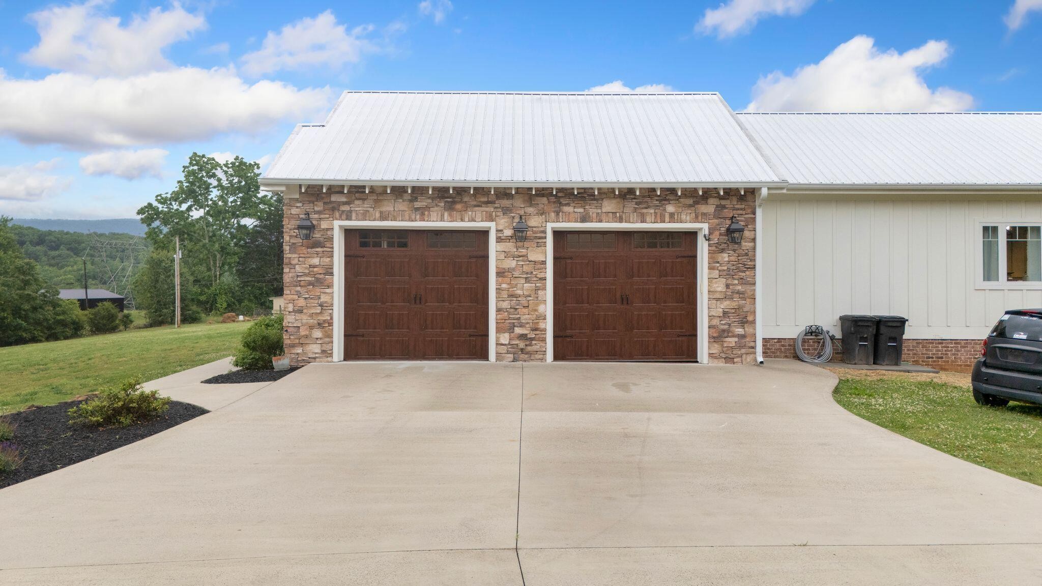 6866 Daus Mountain Road Whitwell, TN 37397 - Photo 46 of 49 a front view of a house with yard and garage