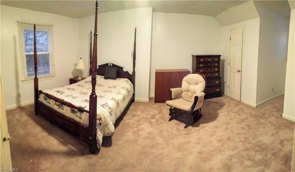 6251 Phillippi Road Julian, NC 27283 - Photo 17 of 30 Bedroom upstairs with lots of room and beautiful views outside!