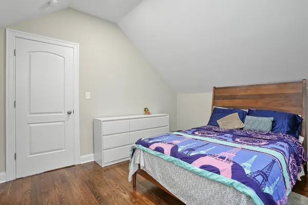 a bedroom with a bed and cabinet