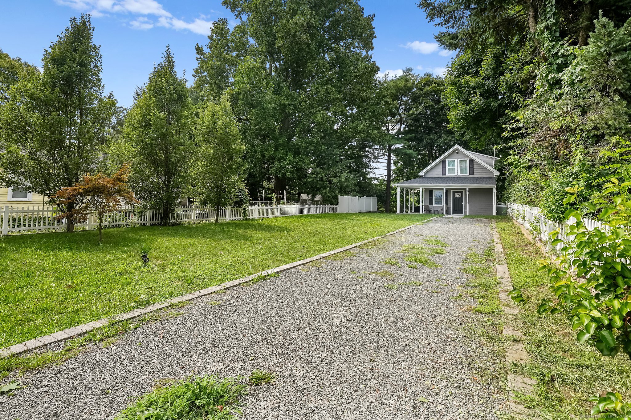 75 Hemlock Street Bridgeport, CT 06605 - Photo 2 of 24 a front view of a house with a yard