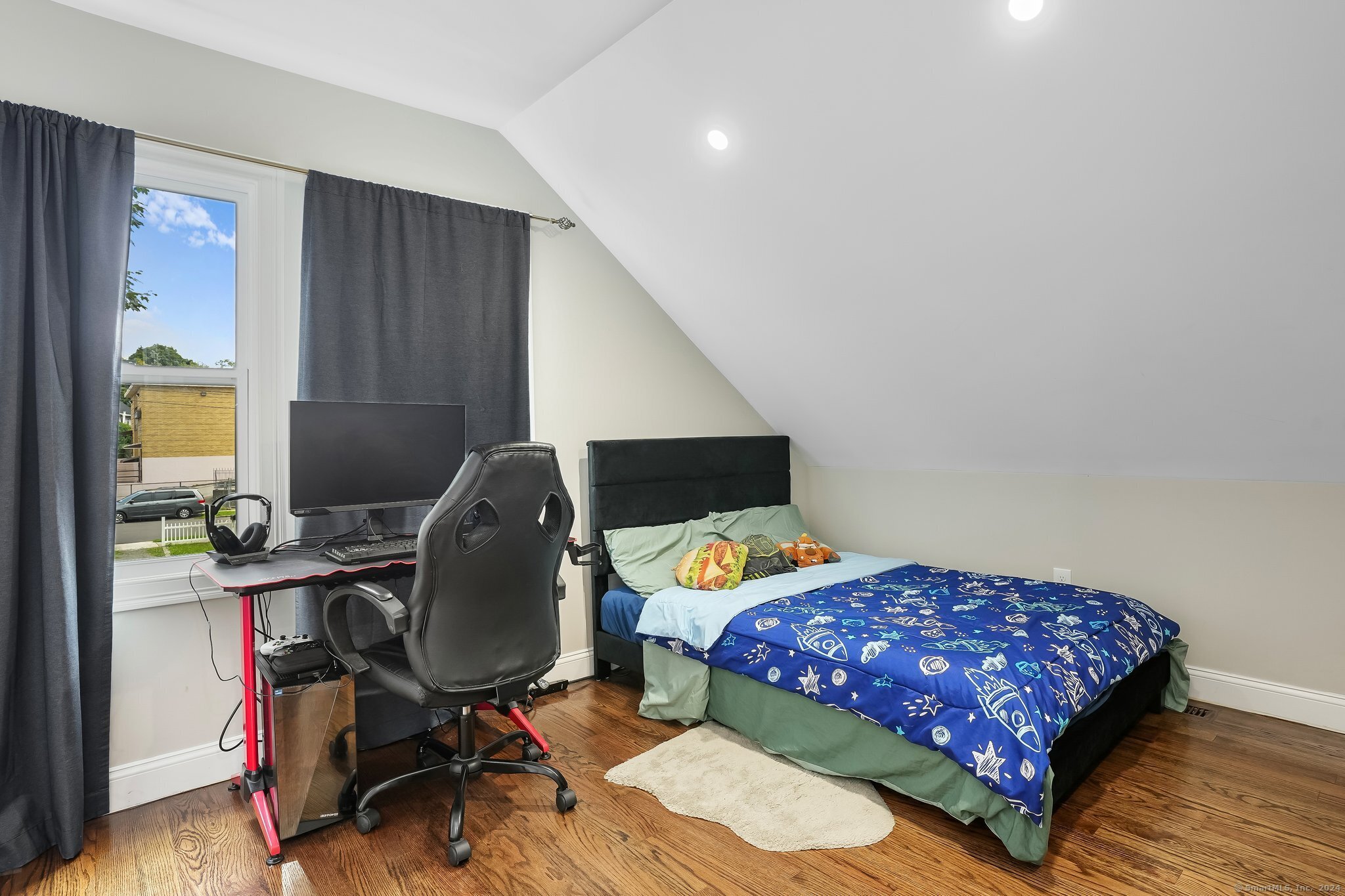 75 Hemlock Street Bridgeport, CT 06605 - Photo 21 of 24 a bedroom with a bed and a flat screen tv