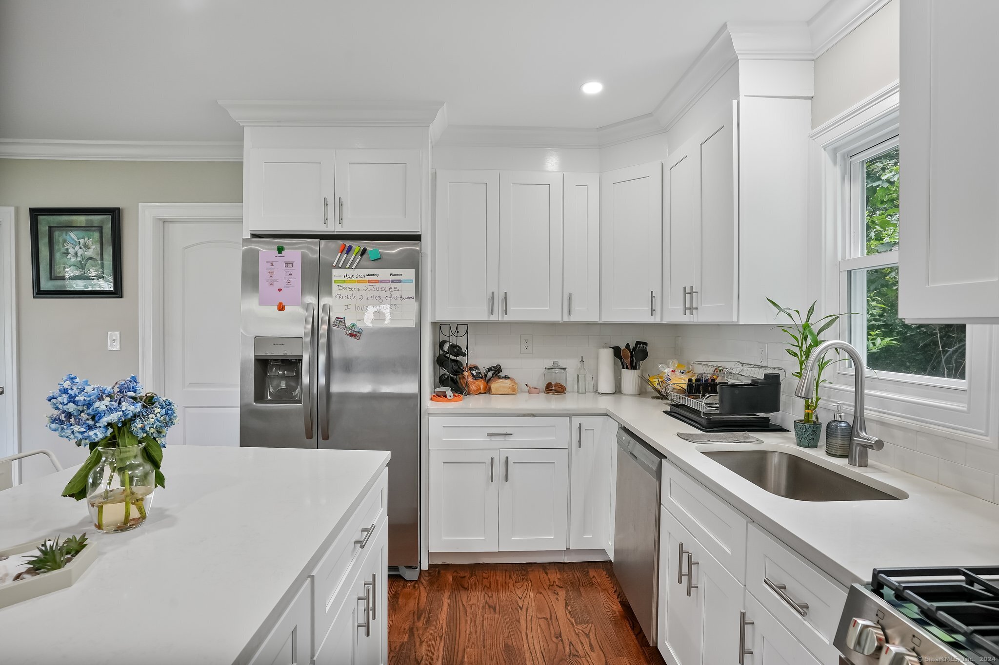 75 Hemlock Street Bridgeport, CT 06605 - Photo 5 of 24 a kitchen with stainless steel appliances a sink a stove a refrigerator a center cabinets and wooden floor
