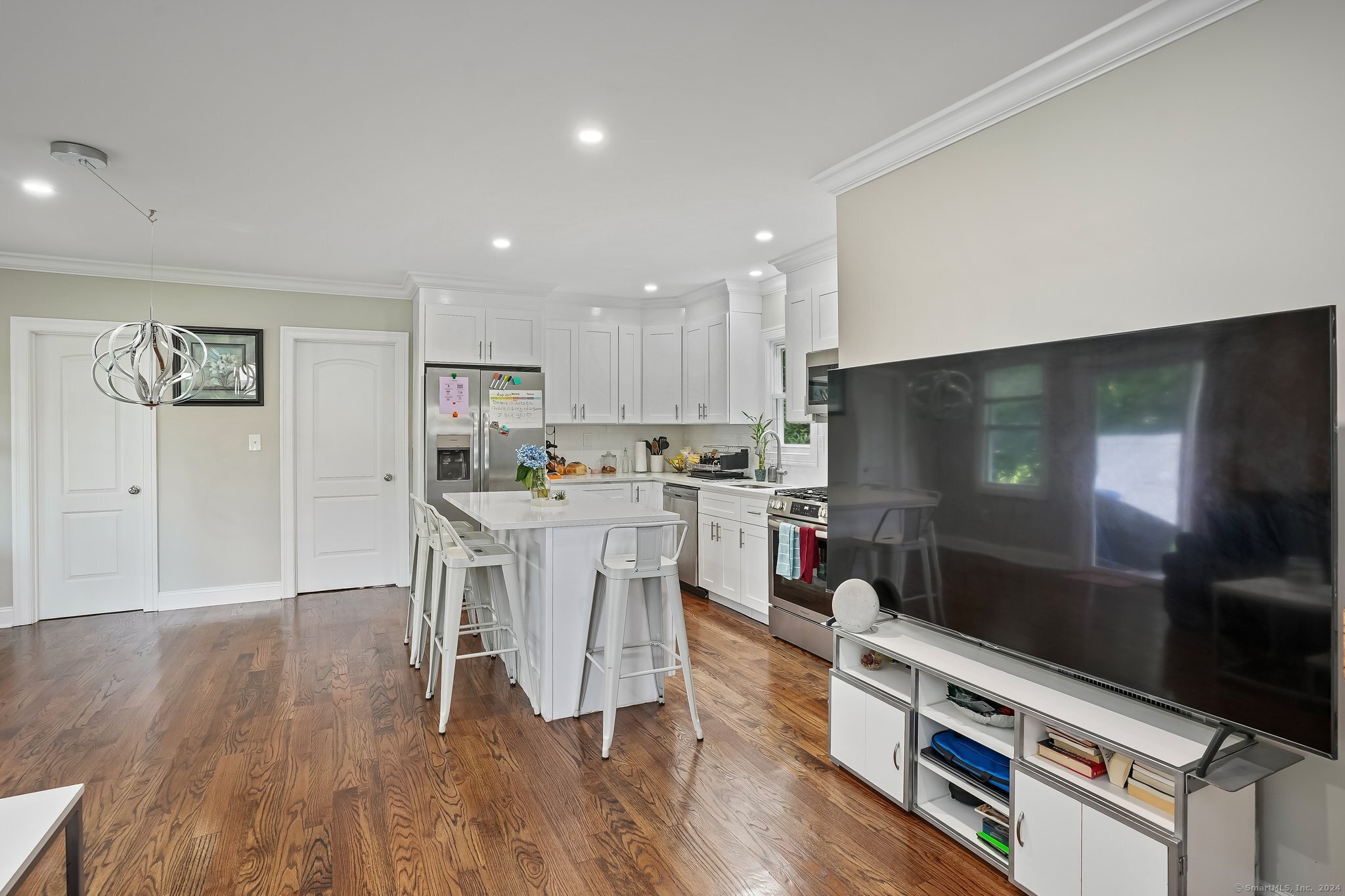 75 Hemlock Street Bridgeport, CT 06605 - Photo 7 of 24 a living room with stainless steel appliances kitchen island hardwood floor and a view of kitchen