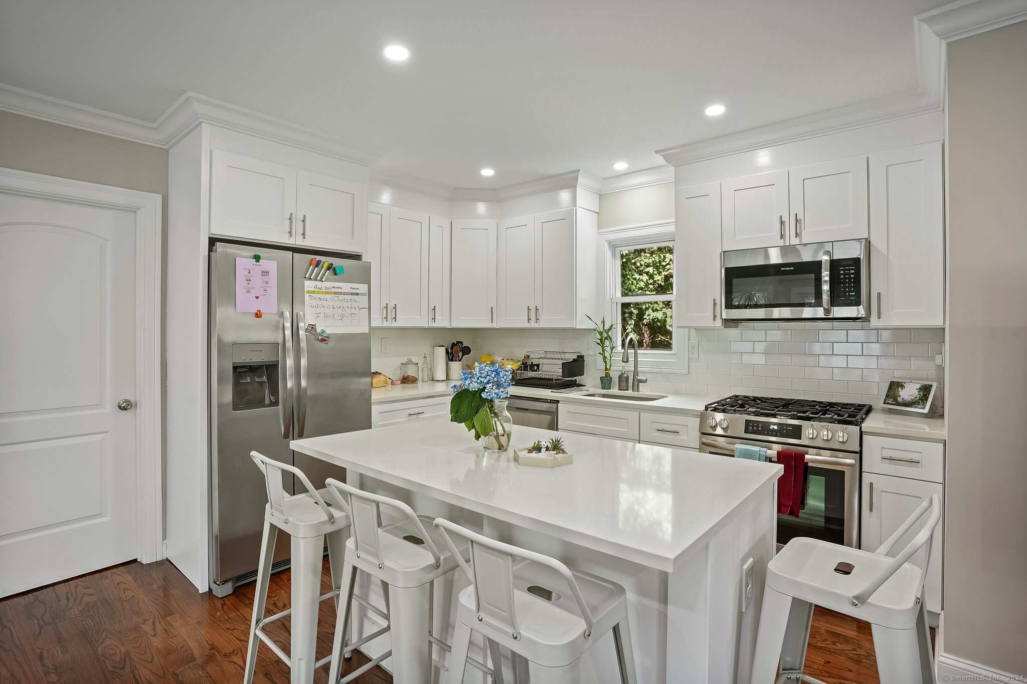75 Hemlock Street Bridgeport, CT 06605 - Photo 8 of 24 a kitchen with stainless steel appliances granite countertop a white cabinets and a refrigerator