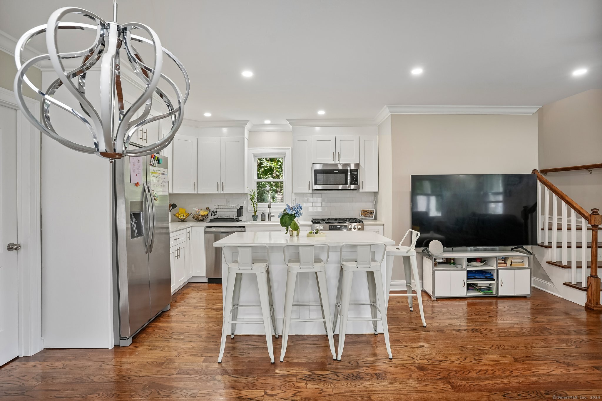 75 Hemlock Street Bridgeport, CT 06605 - Photo 10 of 24 a kitchen with stainless steel appliances kitchen island granite countertop a table and chairs in it