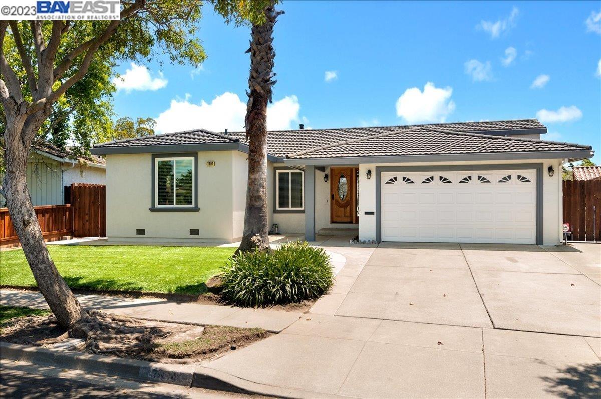 a front view of a house with a garden and entryway