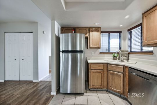 407 South Sunland Street Ridgecrest, CA 93555 - Photo 4 of 28 a kitchen with stainless steel appliances granite countertop a refrigerator and a sink