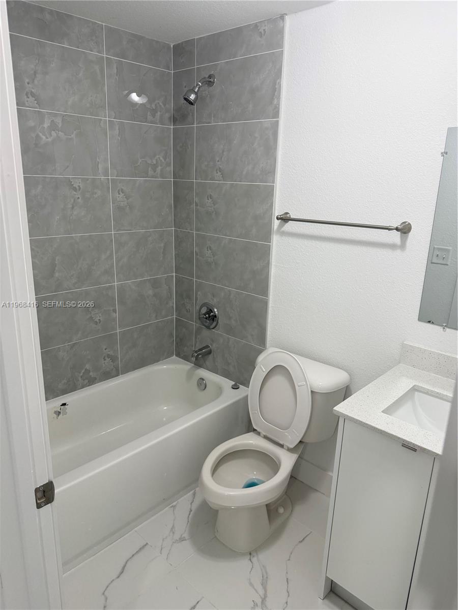 210 Southwest 3rd Street Florida City, FL 33034 - Photo 12 of 15 a bathroom with a toilet a sink and bathtub