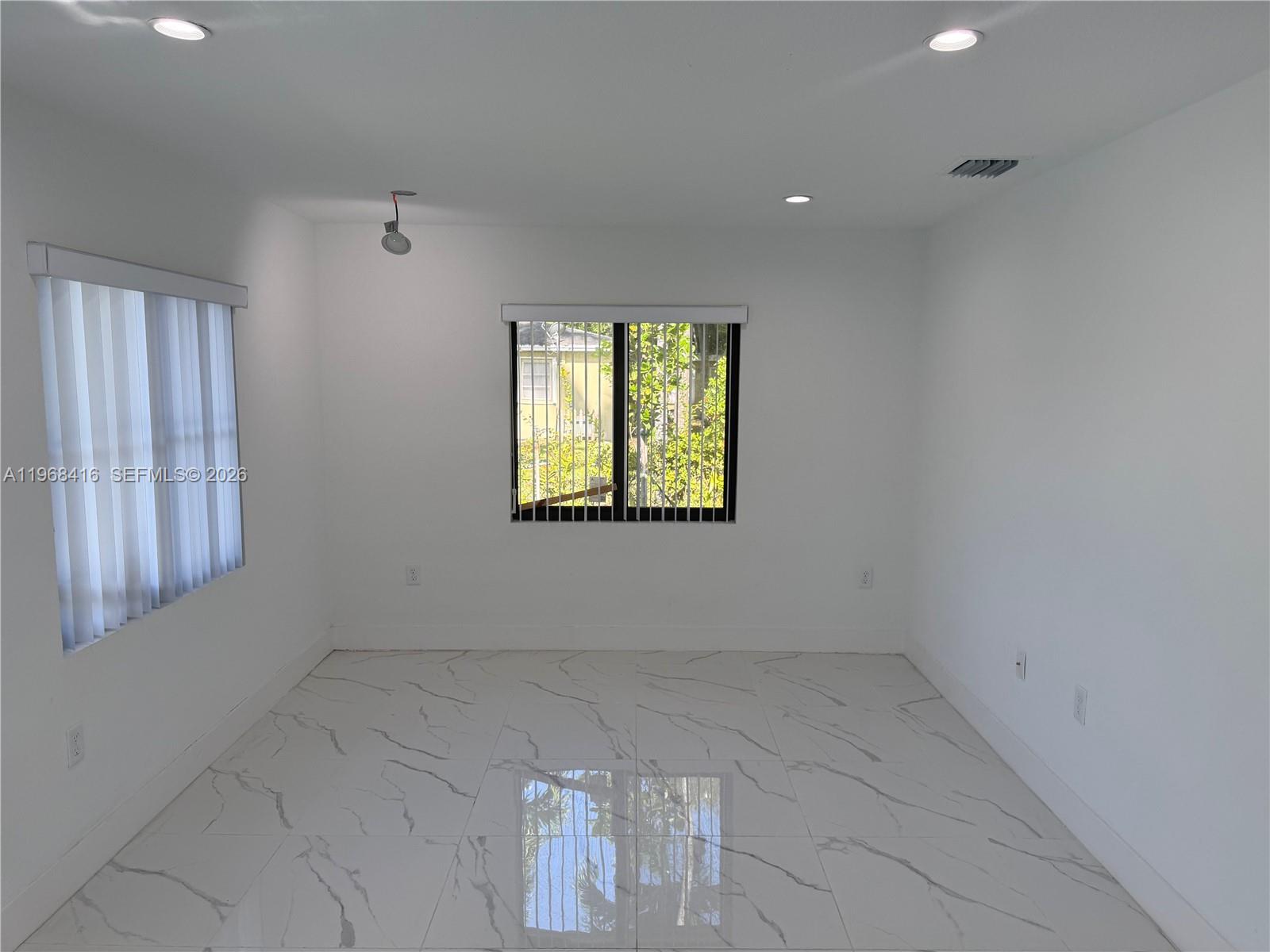 210 Southwest 3rd Street Florida City, FL 33034 - Photo 13 of 15 an empty room with windows