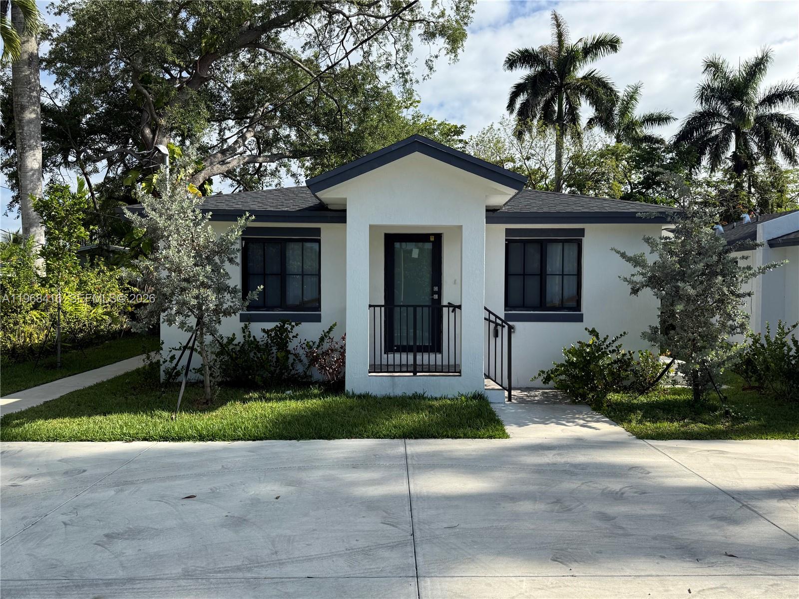 210 Southwest 3rd Street Florida City, FL 33034 - Photo 2 of 15 a house with a yard and a garden