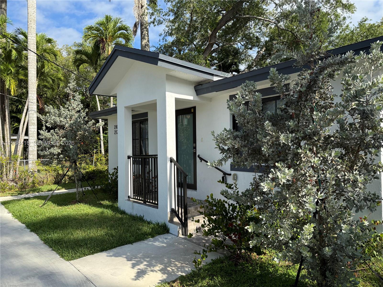 210 Southwest 3rd Street Florida City, FL 33034 - Photo 4 of 15 a front view of a house with garden