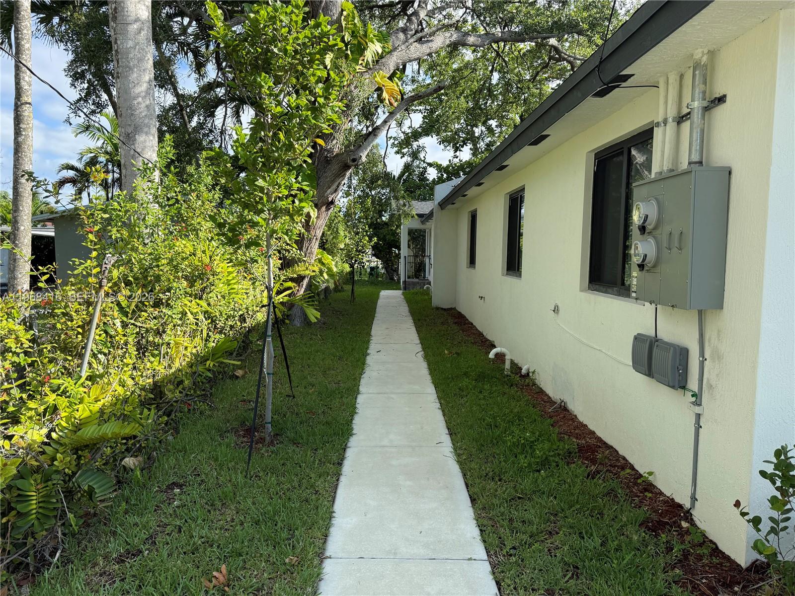 210 Southwest 3rd Street Florida City, FL 33034 - Photo 5 of 15 a pathway of a house with a yard
