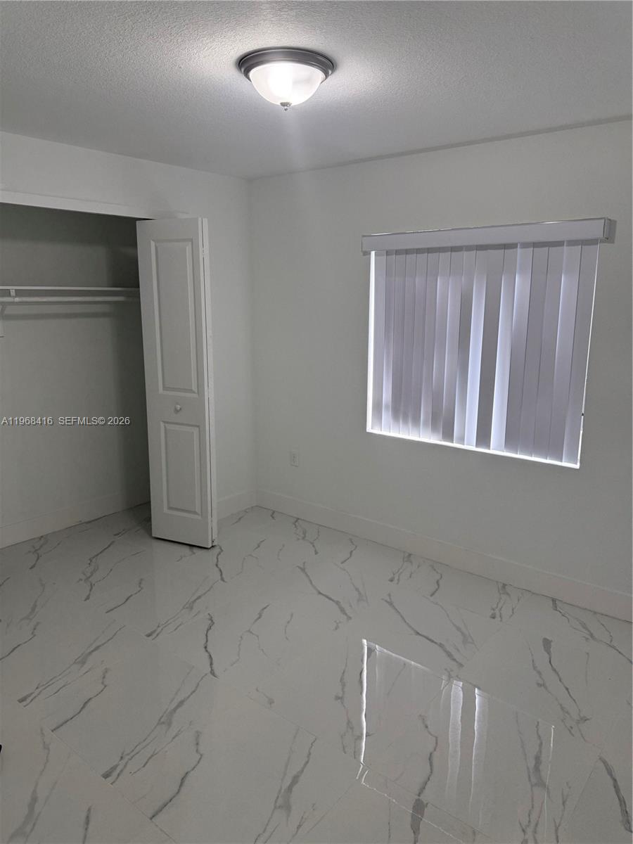 210 Southwest 3rd Street Florida City, FL 33034 - Photo 8 of 15 an empty room with windows