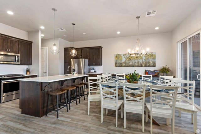 2600 Ocotillo Way, Unit 31 Santa Clara, UT 84765 - Photo 8 of 73 Open-concept kitchen and dining area featuring wood-finish flooring