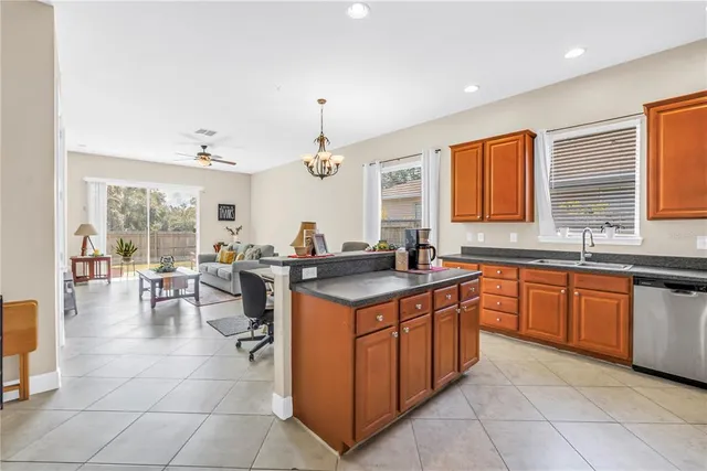 a kitchen with stainless steel appliances granite countertop a sink and cabinets