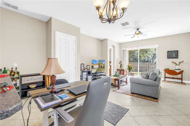 a living room with furniture a flat screen tv and a large window