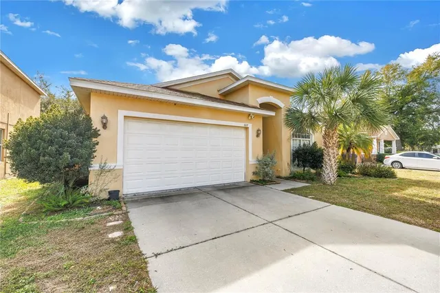 a view of a house with a yard and garage