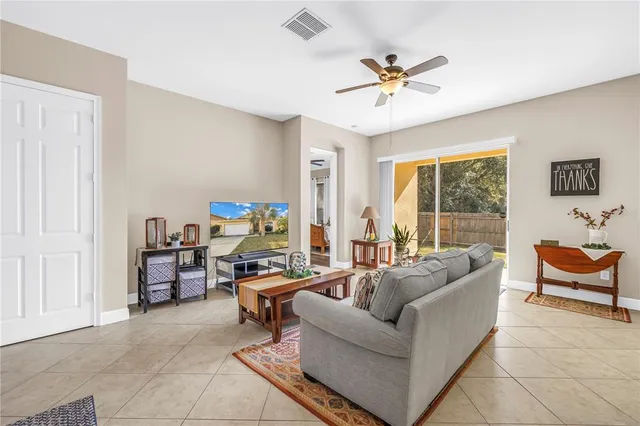 a living room with furniture and a large window with garden view