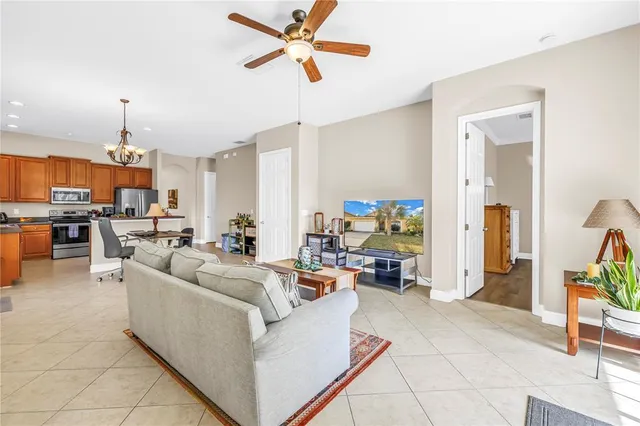 a living room with furniture and a chandelier