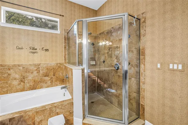 a bathroom with a glass shower door
