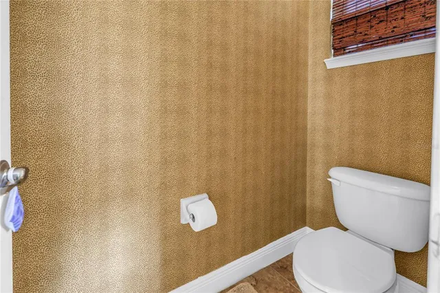 a white toilet sitting next to a small bathroom