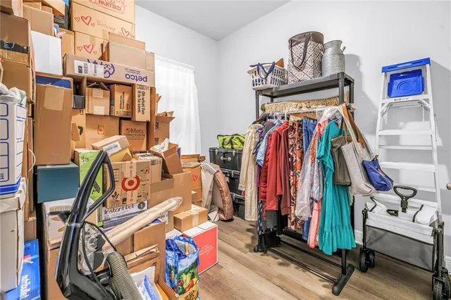a view of walk in closet with clothes and shoes