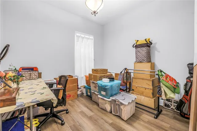a living room with furniture and a workspace