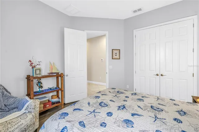 a bedroom with a bed and a dresser in it