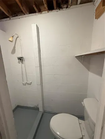 a bathroom with a toilet and a shower