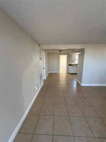 a view of an empty room and a window