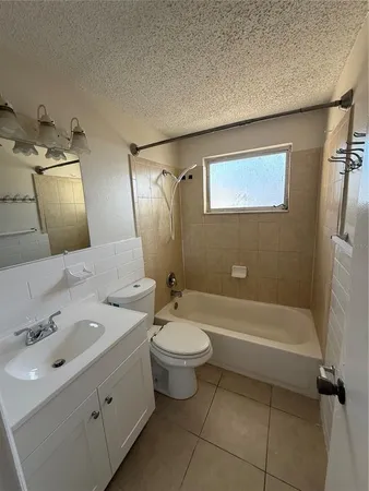 a bathroom with a double vanity sink toilet and shower