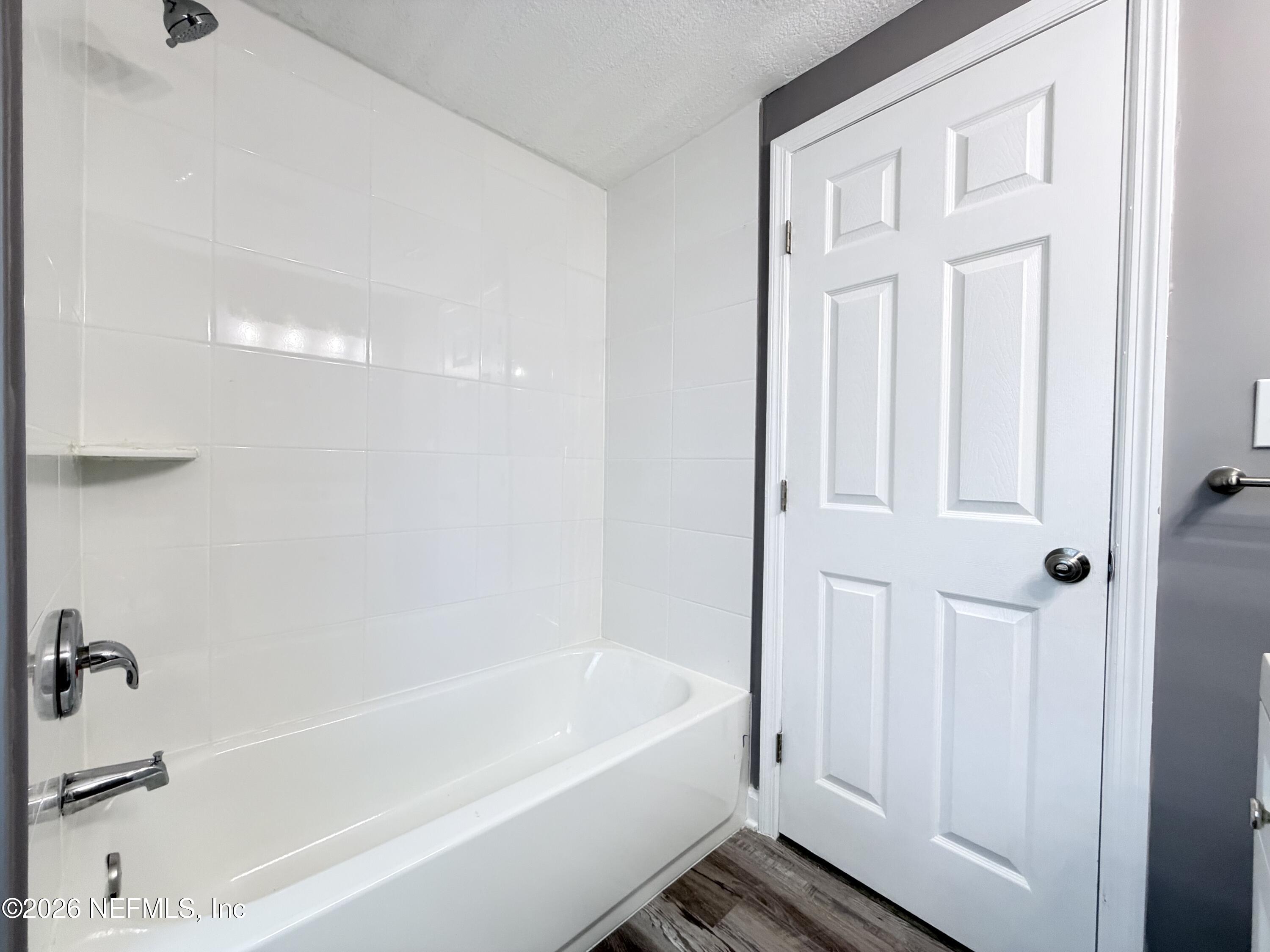 5336 Cruz Road Jacksonville, FL 32207 - Photo 17 of 29 a white bath tub sitting next to a shower