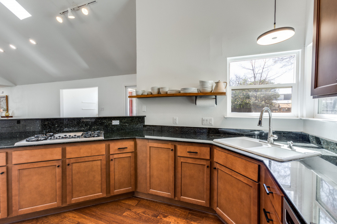 1113 Taulbee Lane Austin, TX 78757 - Photo 11 of 35 a kitchen with granite countertop a sink a stove and cabinets