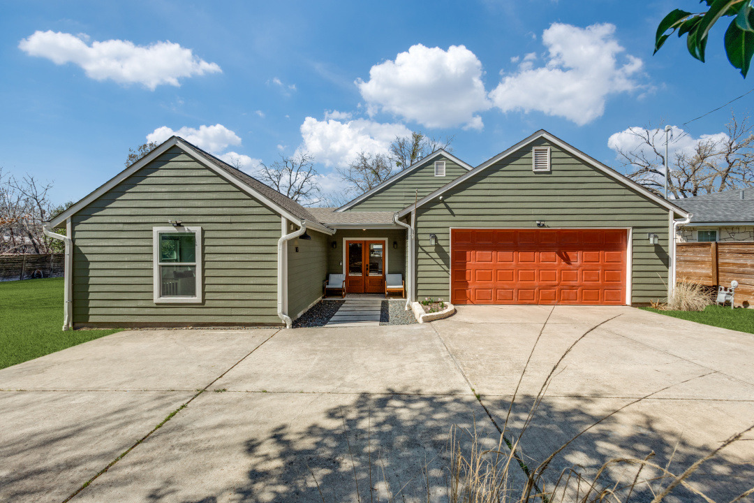 1113 Taulbee Lane Austin, TX 78757 - Photo 2 of 35 a front view of a house with a yard and garage