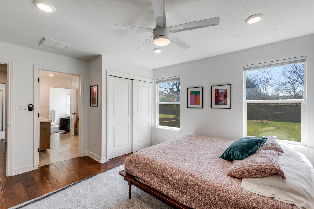 1113 Taulbee Lane Austin, TX 78757 - Photo 24 of 35 a bedroom with a large bed and a window