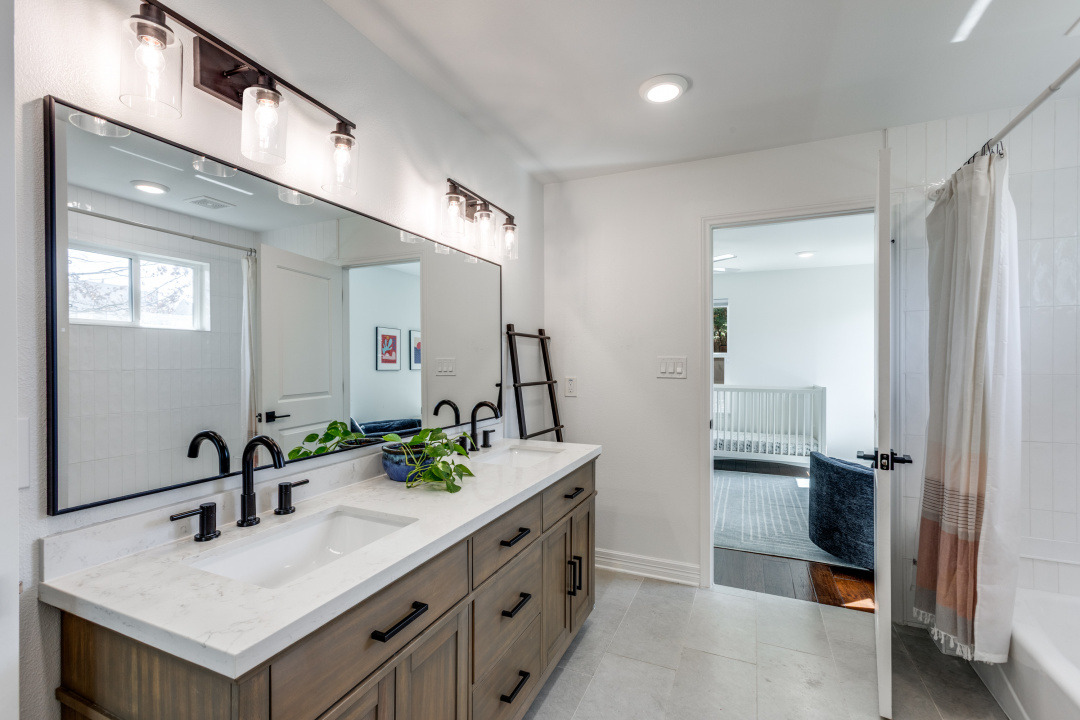 1113 Taulbee Lane Austin, TX 78757 - Photo 28 of 35 a bathroom with double sink and two mirror