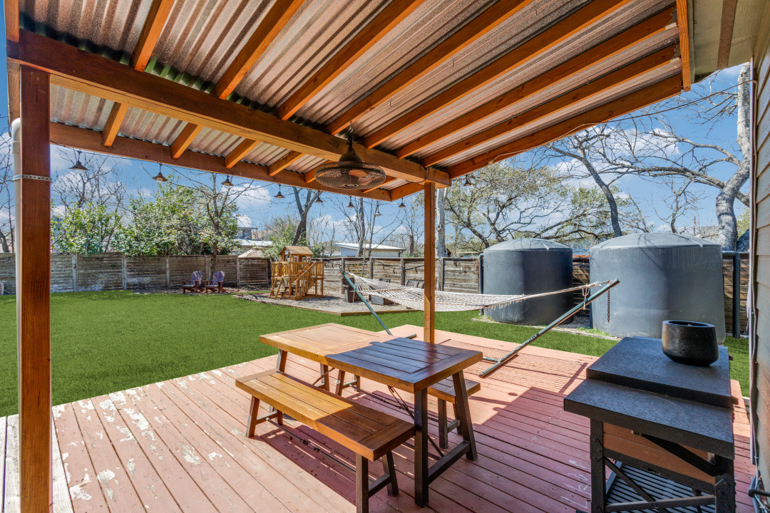 1113 Taulbee Lane Austin, TX 78757 - Photo 29 of 35 a view of a backyard with table and chairs potted plants with wooden floor and fence