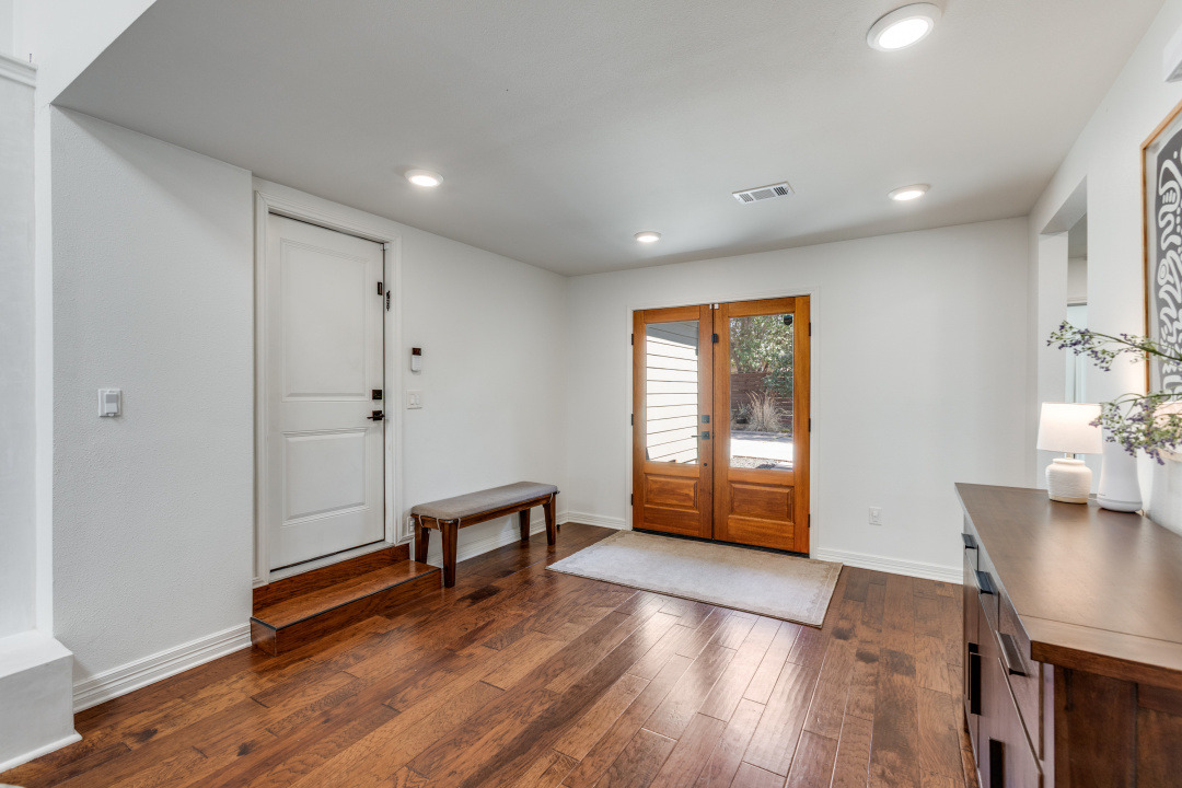 1113 Taulbee Lane Austin, TX 78757 - Photo 4 of 35 a view of an empty room with a window and wooden floor