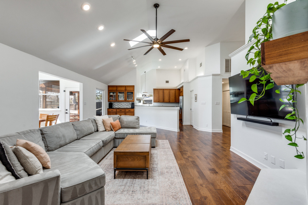 1113 Taulbee Lane Austin, TX 78757 - Photo 9 of 35 a living room with furniture and a chandelier