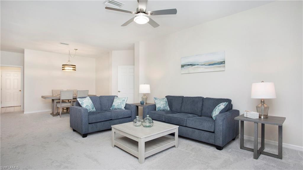 6025 Pinnacle Lane, Unit 6602 Naples, FL 34110 - Photo 11 of 43 a living room with furniture a bed and a couch