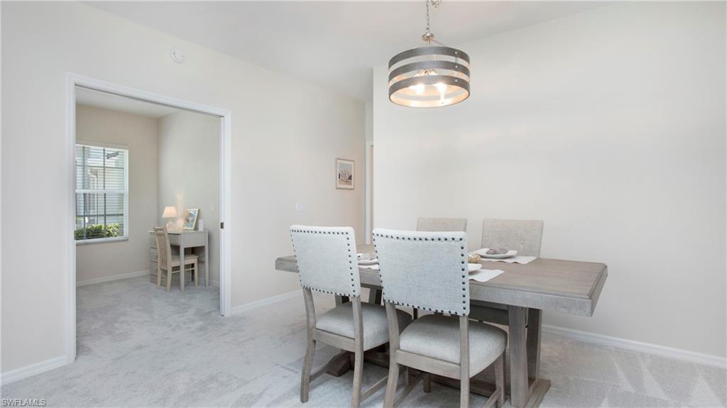 6025 Pinnacle Lane, Unit 6602 Naples, FL 34110 - Photo 13 of 43 a view of a dining room with furniture and chandelier