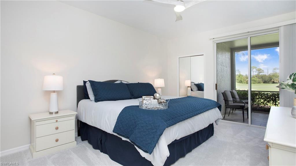 6025 Pinnacle Lane, Unit 6602 Naples, FL 34110 - Photo 14 of 43 a bedroom with a bed and a lamp