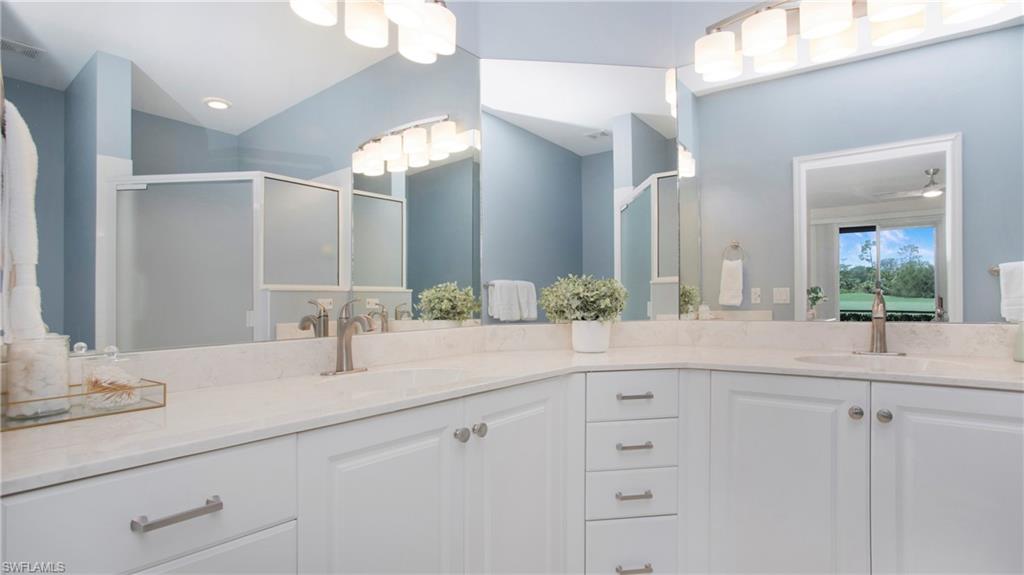 6025 Pinnacle Lane, Unit 6602 Naples, FL 34110 - Photo 16 of 43 a bathroom with a sink and a mirror