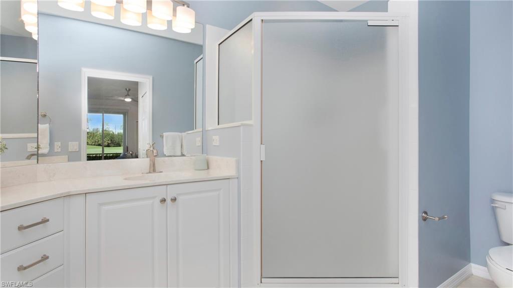 6025 Pinnacle Lane, Unit 6602 Naples, FL 34110 - Photo 17 of 43 a bathroom with a sink and a mirror