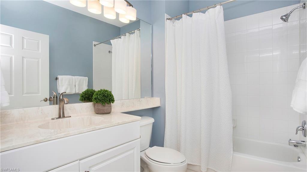 6025 Pinnacle Lane, Unit 6602 Naples, FL 34110 - Photo 19 of 43 a bathroom with a sink a toilet and shower